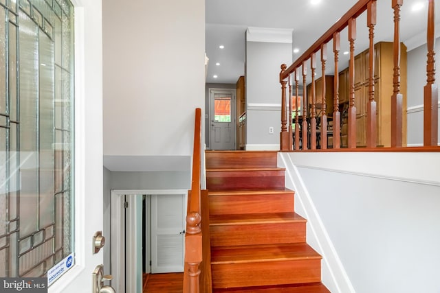 staircase featuring recessed lighting and wood finished floors