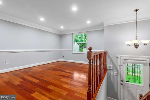 stairs with crown molding, a chandelier, wood finished floors, baseboards, and recessed lighting