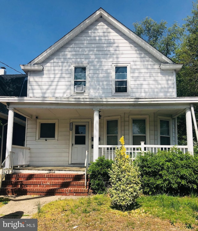 farmhouse with a porch and cooling unit