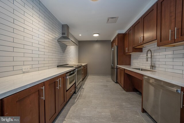 1655 Oakwood Dr Unit N323, Narberth, PA 19072 - kitchen featuring appliances with stainless steel finishes, a sink, wall chimney range hood, and decorative backsplash