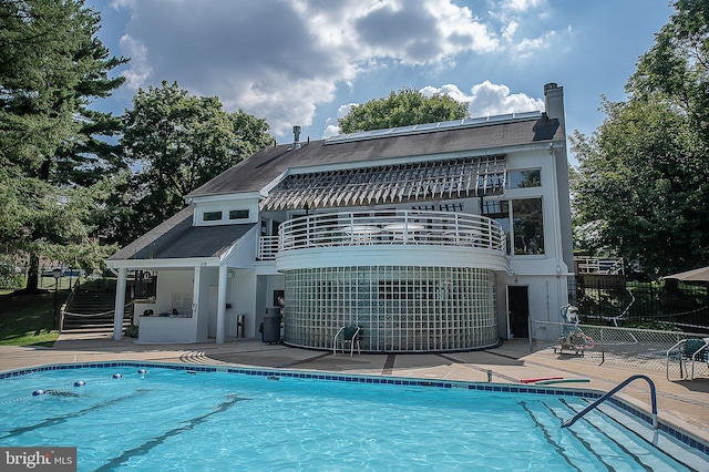 1655 Oakwood Dr Unit N323, Narberth, PA 19072 - rear view of house with a balcony, a patio, and a chimney