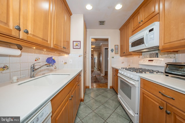 1655 Oakwood Dr Unit N323, Narberth, PA 19072 - kitchen with white appliances, a sink, light countertops, backsplash, and tile patterned flooring