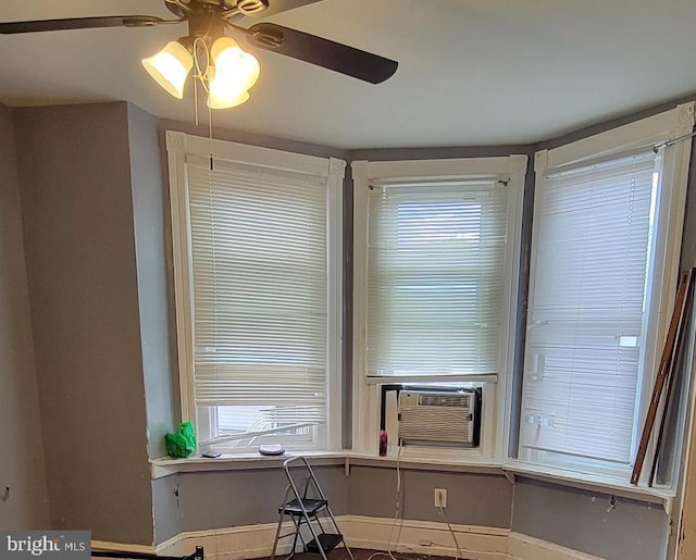 detailed view of a ceiling fan, baseboards, and cooling unit