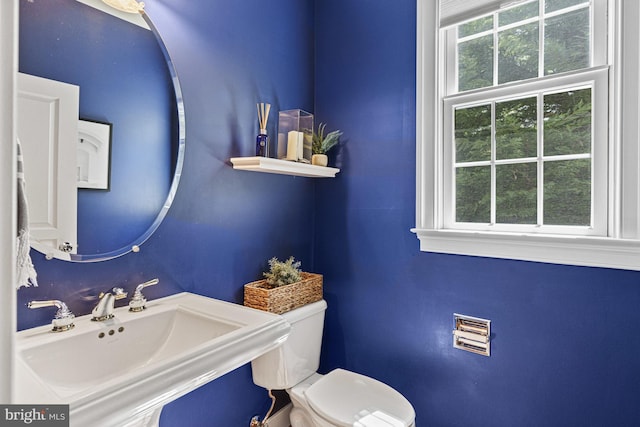 half bath featuring a sink and toilet