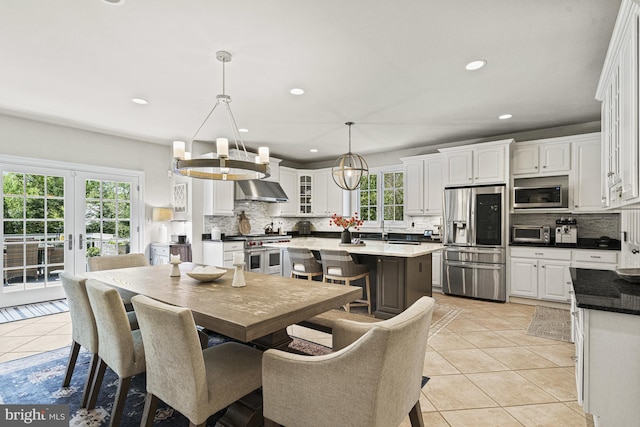 dining area with light tile patterned floors and recessed lighting