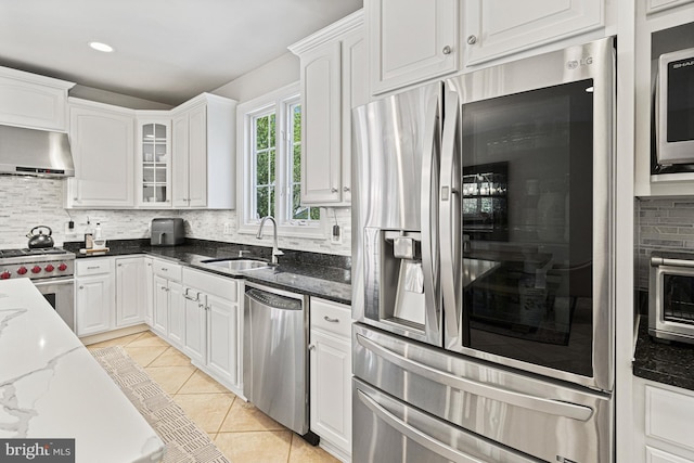 kitchen featuring stainless steel appliances, a sink, tasteful backsplash, ventilation hood, and recessed lighting