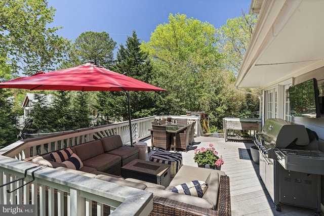 wooden deck with an outdoor living space, outdoor dining space, and view of wooded area