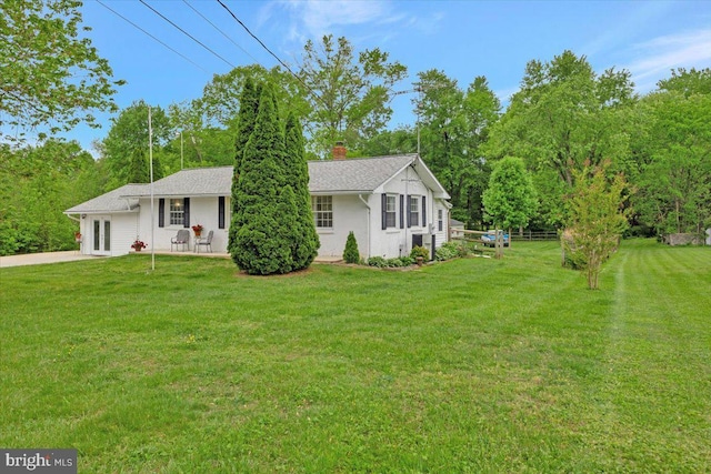 ranch-style house with a front lawn and a chimney