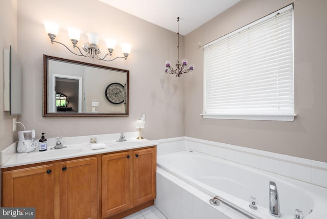 full bath with a garden tub, double vanity, and a chandelier