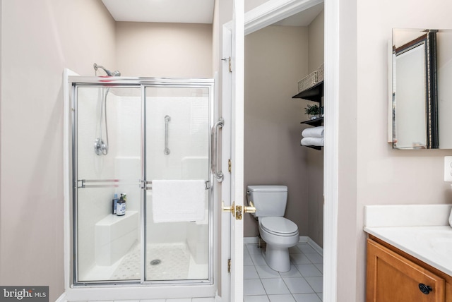 full bath with a stall shower, tile patterned flooring, toilet, baseboards, and vanity