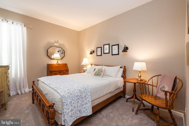 carpeted bedroom featuring baseboards