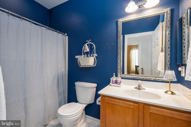 full bath with toilet, vanity, and tile patterned flooring