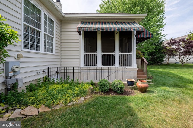 doorway to property with a yard and a chimney