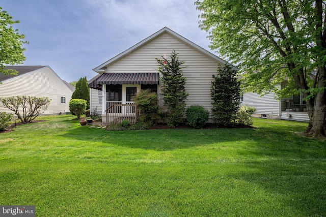 back of house with a yard