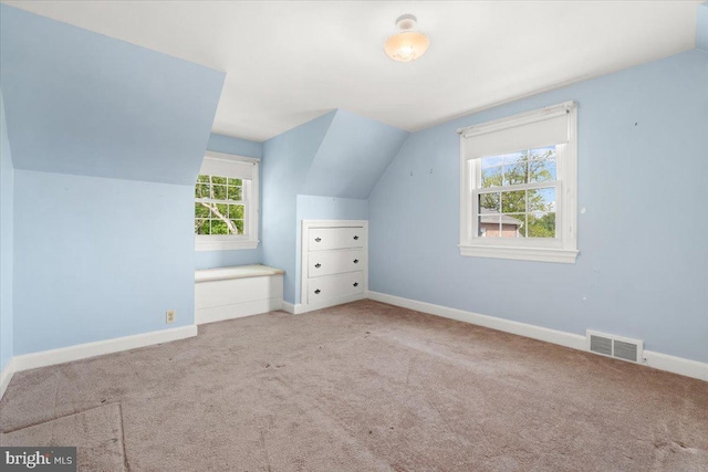 bonus room with lofted ceiling, carpet, and baseboards