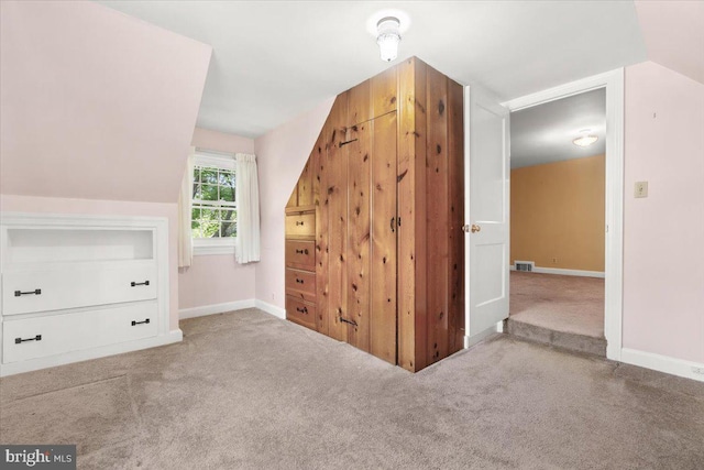 bonus room with carpet flooring and baseboards