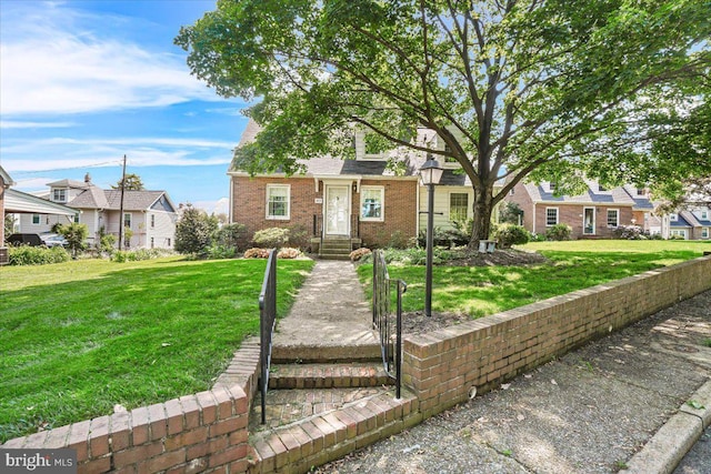 view of front of home with a residential view, a front lawn, and brick siding