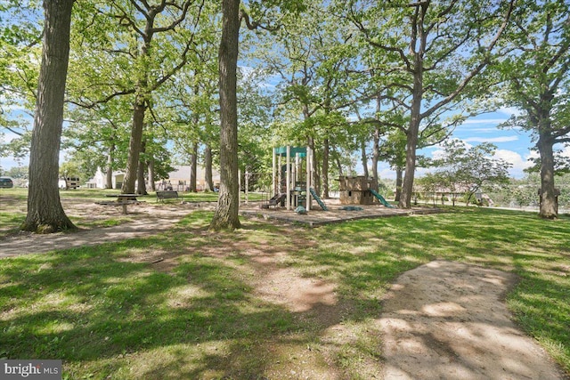 view of green lawn featuring a playground