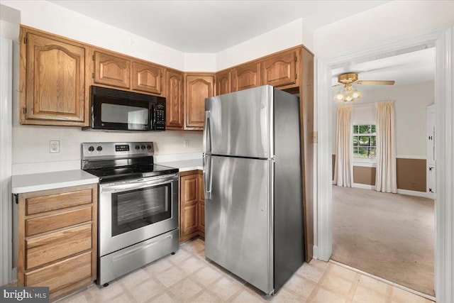 kitchen featuring appliances with stainless steel finishes, light countertops, brown cabinets, ceiling fan, and light floors