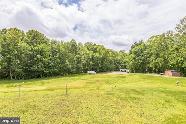 7290 Southern Maryland Blvd, Owings, MD 20736 - view of grassy yard featuring a storage unit, view of golf course, and an outbuilding
