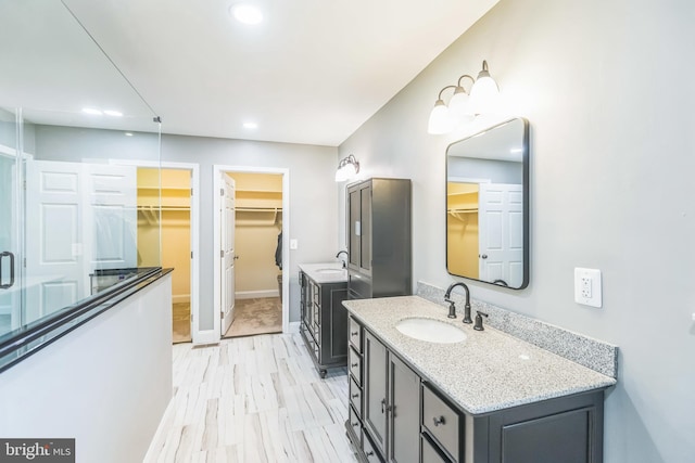 7290 Southern Maryland Blvd, Owings, MD 20736 - bathroom featuring recessed lighting, two vanities, a walk in closet, and baseboards