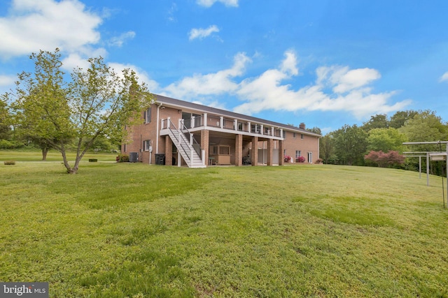 7290 Southern Maryland Blvd, Owings, MD 20736 - rear view of house featuring stairway, a wooden deck, brick siding, and a lawn