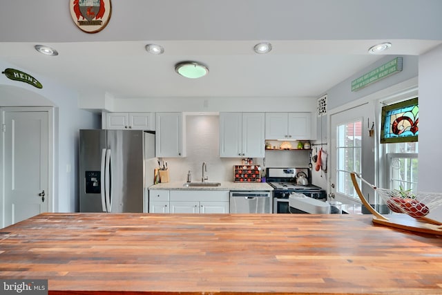 409 Academy Rd, Baltimore, MD 21228 - kitchen with a sink, stainless steel appliances, wooden counters, backsplash, and recessed lighting