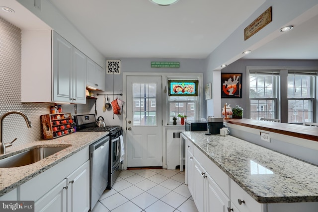 409 Academy Rd, Baltimore, MD 21228 - kitchen with a sink, stainless steel appliances, healthy amount of natural light, and light tile patterned floors