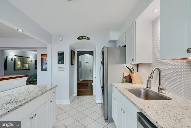 409 Academy Rd, Baltimore, MD 21228 - kitchen with a sink, tasteful backsplash, white cabinets, light tile patterned floors, and light stone countertops