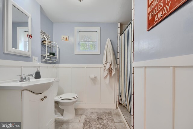 409 Academy Rd, Baltimore, MD 21228 - bathroom with toilet, vanity, wainscoting, a shower with shower curtain, and tile patterned flooring
