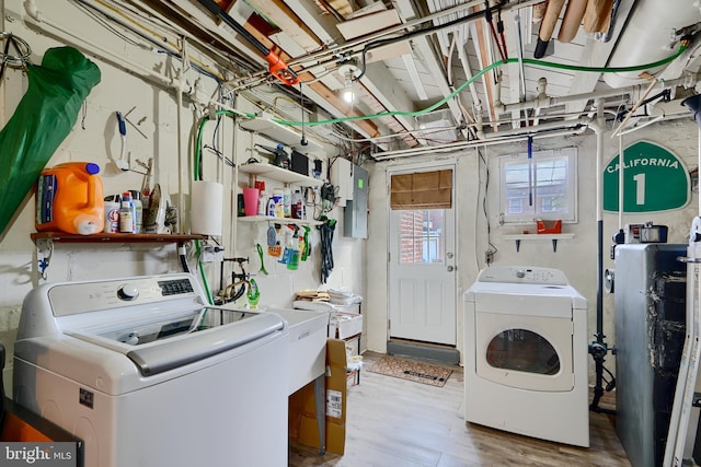 409 Academy Rd, Baltimore, MD 21228 - clothes washing area with washer and dryer, electric panel, and wood finished floors