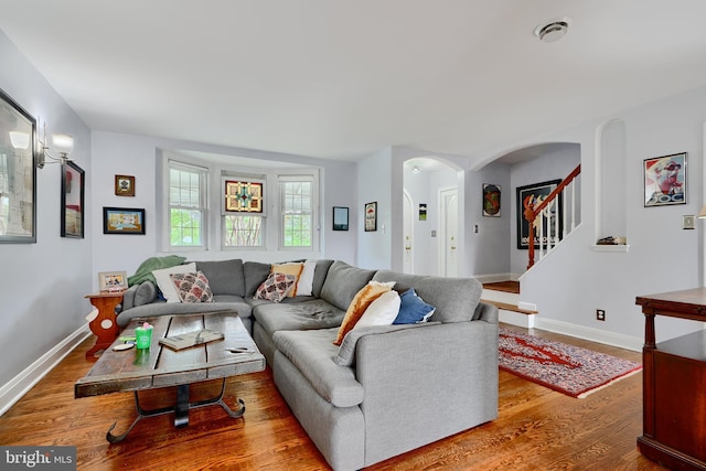 409 Academy Rd, Baltimore, MD 21228 - living area with arched walkways, wood finished floors, baseboards, and stairs