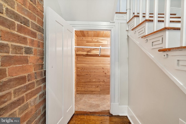 walk in closet with wood finished floors