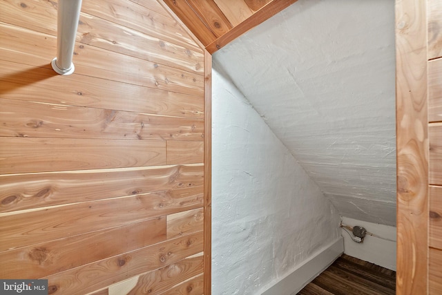 additional living space featuring lofted ceiling and wood finished floors