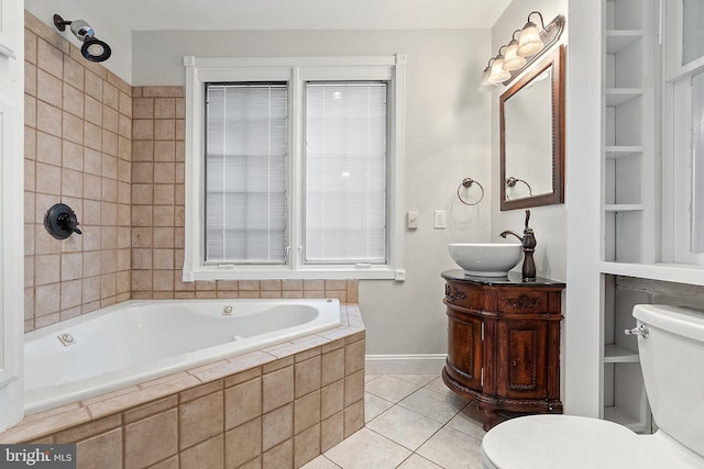 full bathroom featuring toilet, tiled tub, tile patterned flooring, vanity, and baseboards