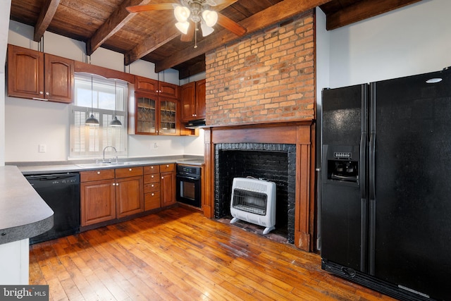 kitchen with black appliances, wooden ceiling, a sink, heating unit, and beam ceiling