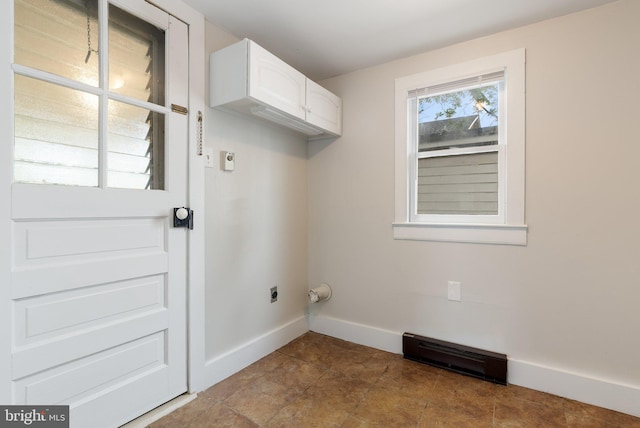washroom featuring cabinet space, baseboards, and electric dryer hookup
