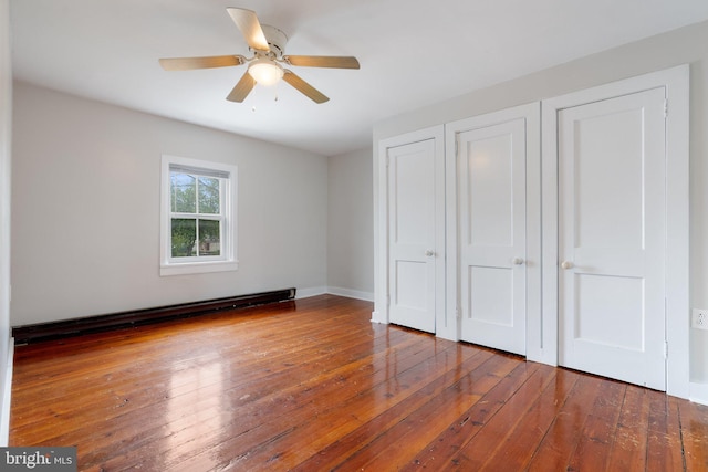 unfurnished bedroom with a baseboard radiator, wood-type flooring, and ceiling fan