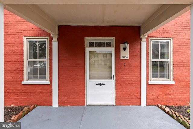 view of exterior entry with a porch