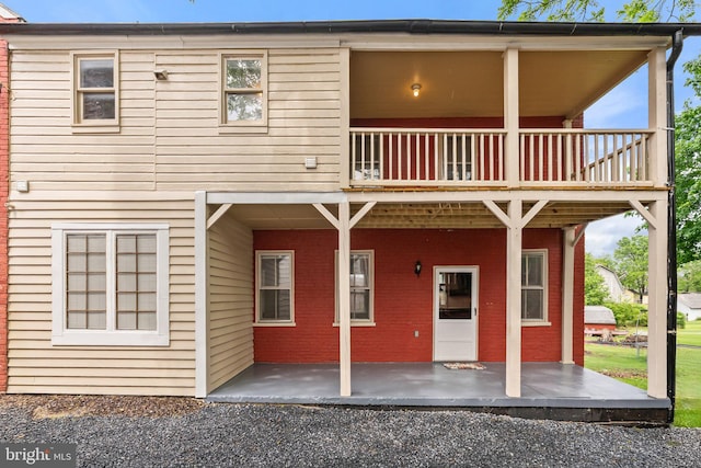 rear view of house with a patio and a balcony