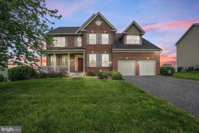 13324 John Martin Dr, Williamsport, MD 21795 - view of front of home featuring a porch, a lawn, brick siding, and driveway
