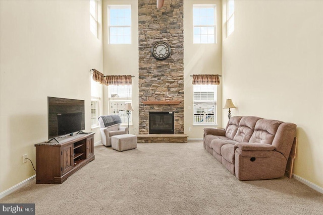 13324 John Martin Dr, Williamsport, MD 21795 - carpeted living area with baseboards, plenty of natural light, a fireplace, and a high ceiling