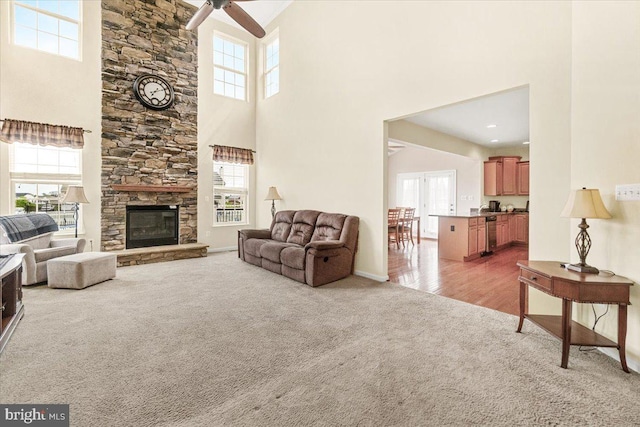 13324 John Martin Dr, Williamsport, MD 21795 - living area featuring ceiling fan, light carpet, a high ceiling, baseboards, and a stone fireplace