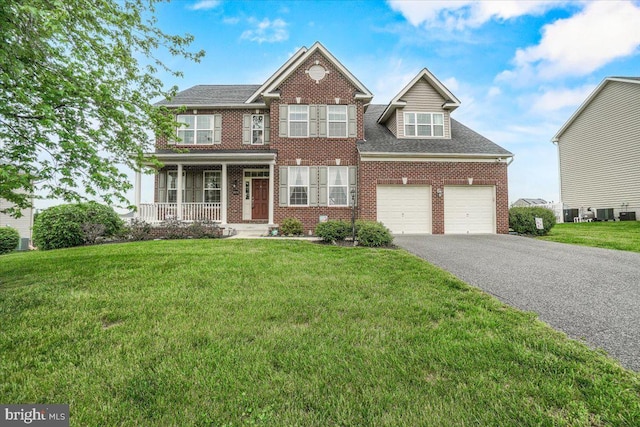 13324 John Martin Dr, Williamsport, MD 21795 - view of front of property with brick siding, an attached garage, a front yard, a porch, and aphalt driveway