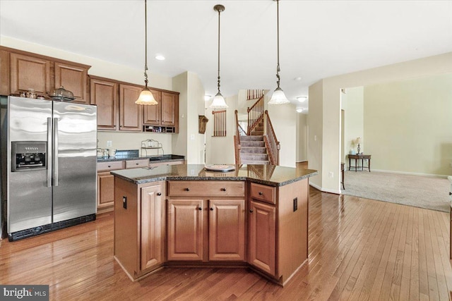 13324 John Martin Dr, Williamsport, MD 21795 - kitchen with stainless steel fridge with ice dispenser, a kitchen island, wood-type flooring, pendant lighting, and recessed lighting