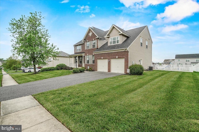 13324 John Martin Dr, Williamsport, MD 21795 - traditional-style house featuring a garage, fence, aphalt driveway, a front yard, and brick siding