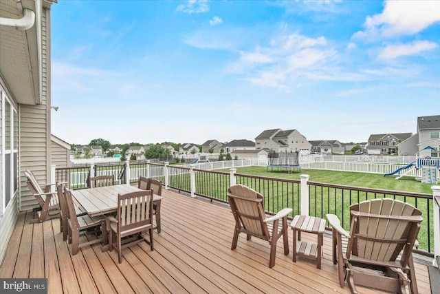 13324 John Martin Dr, Williamsport, MD 21795 - wooden deck with a yard, outdoor dining space, a trampoline, a residential view, and a playground