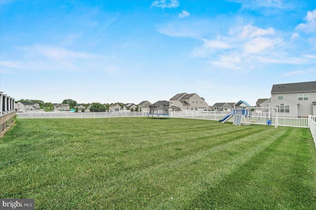 13324 John Martin Dr, Williamsport, MD 21795 - view of yard featuring playground community, a trampoline, a residential view, and a fenced backyard
