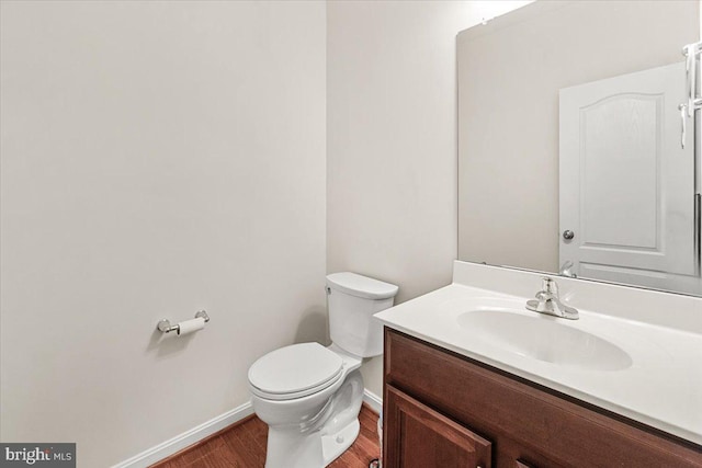 13324 John Martin Dr, Williamsport, MD 21795 - half bathroom with baseboards, vanity, toilet, and wood finished floors