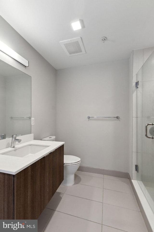 full bathroom with tile patterned floors, a shower stall, vanity, toilet, and baseboards